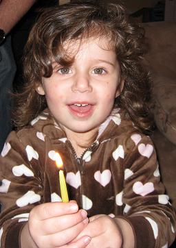 Zoe with Hanukkah candle